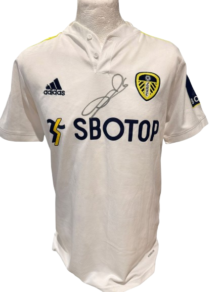 Official Leeds United home shirt hand-signed by captain Liam Cooper in bold permanent ink.