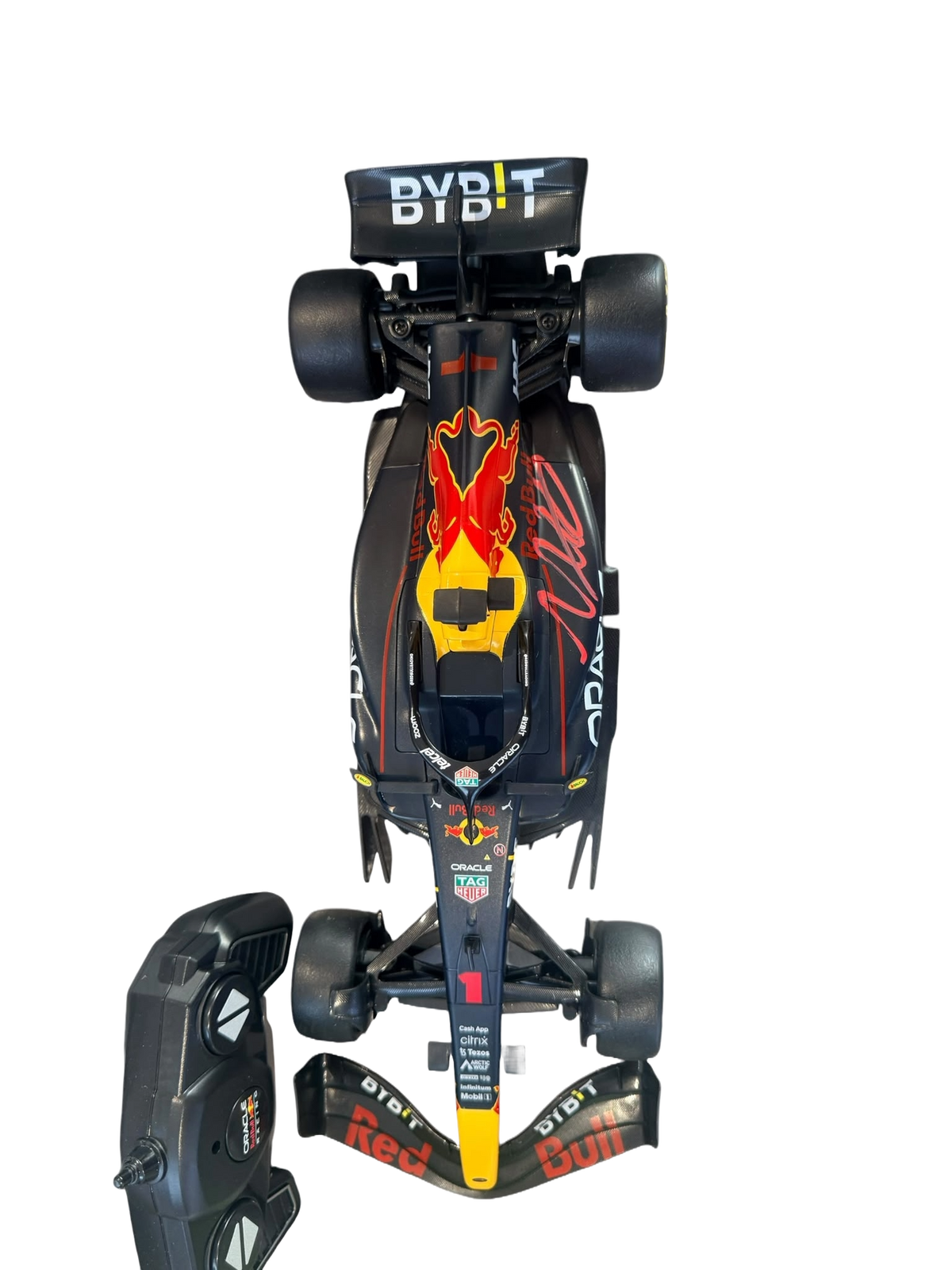 Max Verstappen signed remote control Red Bull F1 car displayed alongside its accompanying handheld remote control unit.
