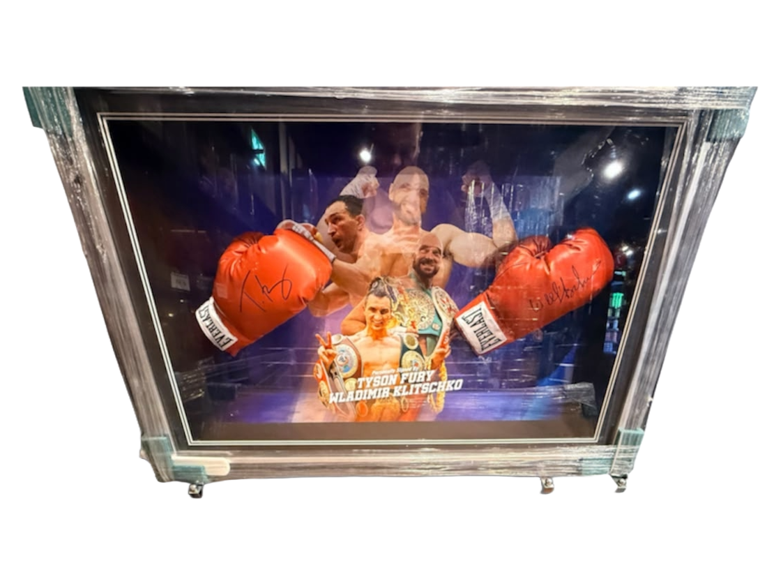 Signed Tyson Fury and Wladimir Klitschko dual framed boxing gloves featuring hand-signed autographs from both heavyweight champions set against bespoke artwork