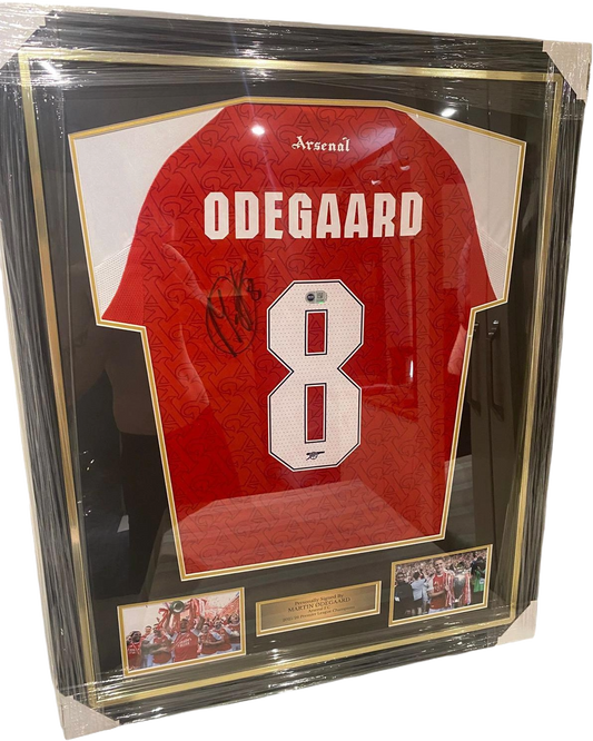 Professionally framed Martin Odegaard signed Arsenal home and away jerseys from the 2025/26 Premier League title-winning season.