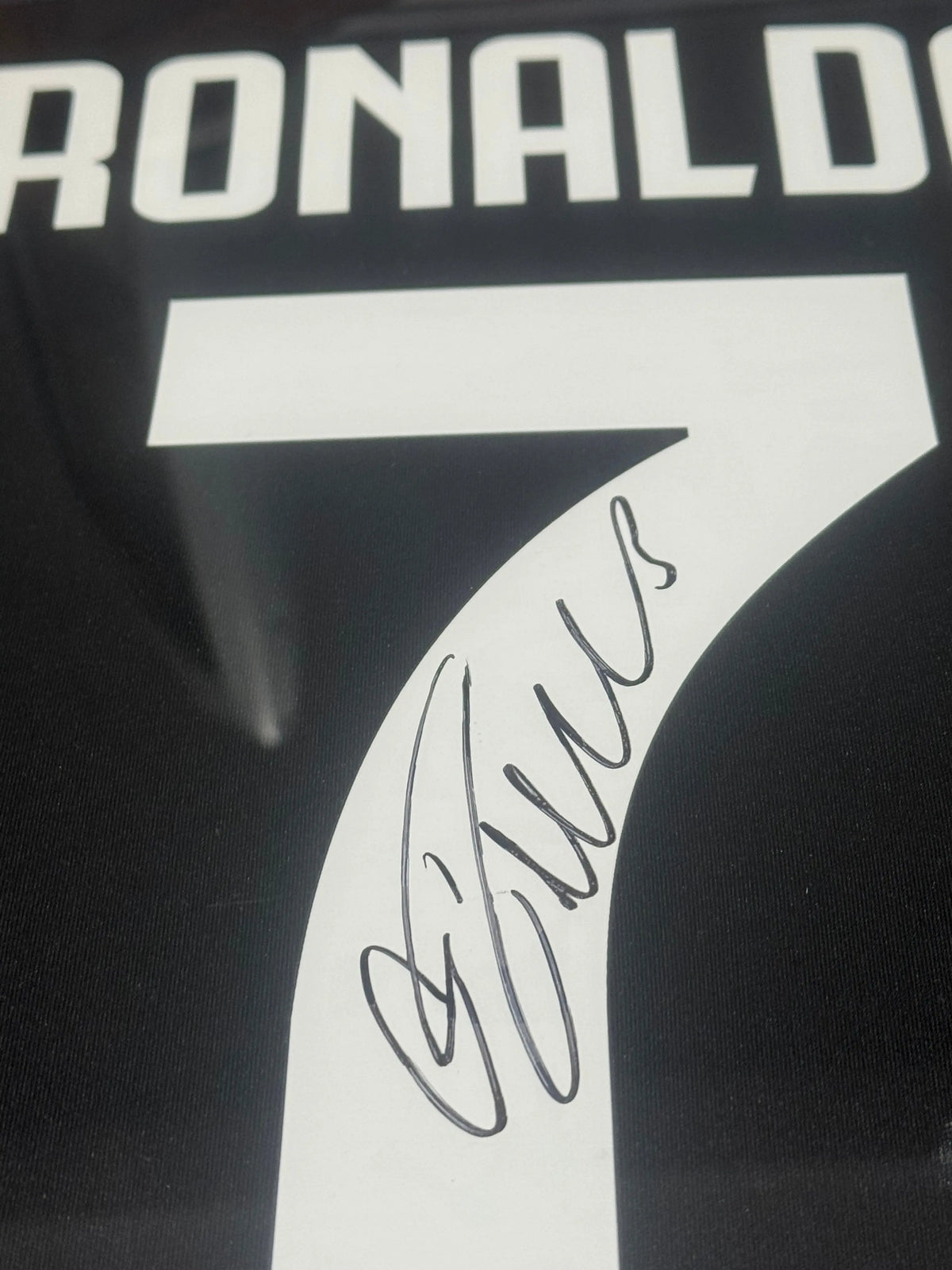 Deluxe framed 2019/20 Juventus Home Shirt, hand-signed by Cristiano Ronaldo. The frame includes plaques, montage photos, and a clear view of the signature.