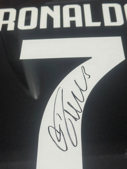 Deluxe framed 2019/20 Juventus Home Shirt, hand-signed by Cristiano Ronaldo. The frame includes plaques, montage photos, and a clear view of the signature.