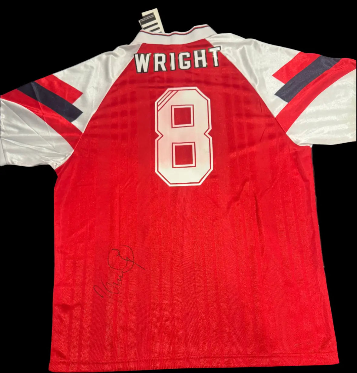 Signed Arsenal 92-94 Retro Home Shirt by Ian Wright, showing the classic design and signature. Small red stain is visible on the back number.