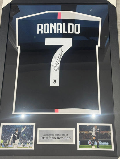 Deluxe framed 2019/20 Juventus Home Shirt, hand-signed by Cristiano Ronaldo. The frame includes plaques, montage photos, and a clear view of the signature.