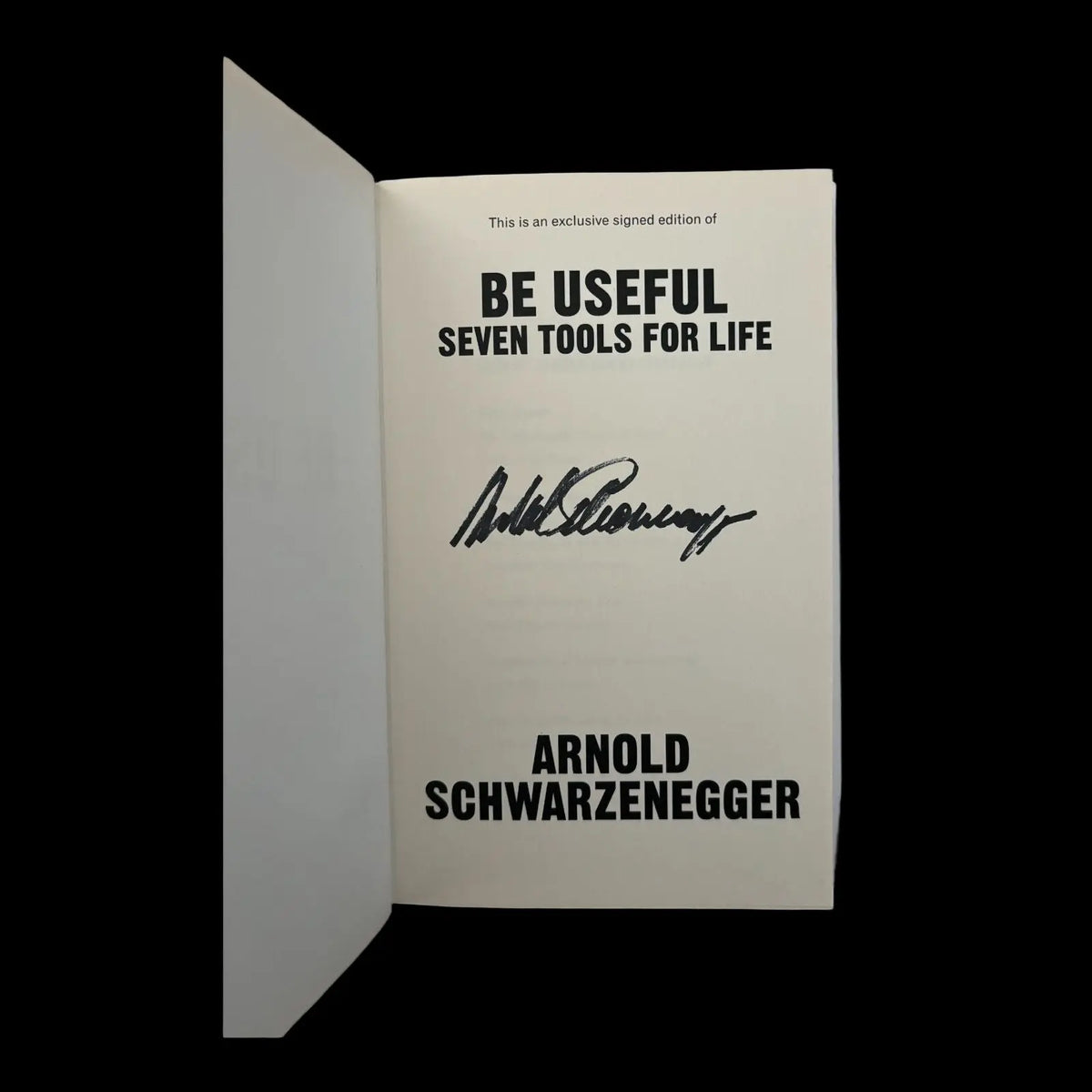 Signed book by Arnold Schwarzenegger, showing his clear, bold signature on the opening page. Book cover and signature are visible.