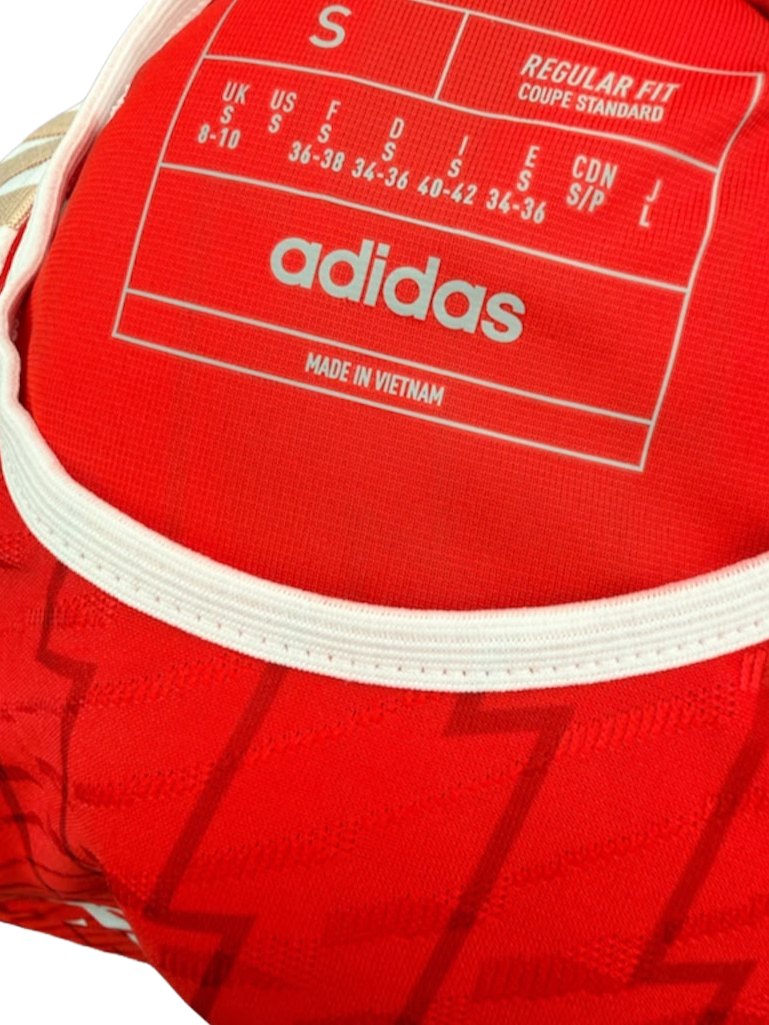 Close up view of the inside collar showing printed size details on the Adidas Arsenal shirt