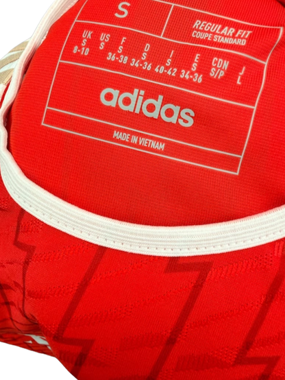 Close up view of the inside collar showing printed size details on the Adidas Arsenal shirt