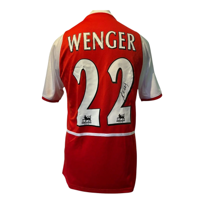 Authentic Arsene Wenger signed Arsenal home shirt, featuring a bold black autograph on the iconic red and white O2 sponsored Invincibles era jersey.