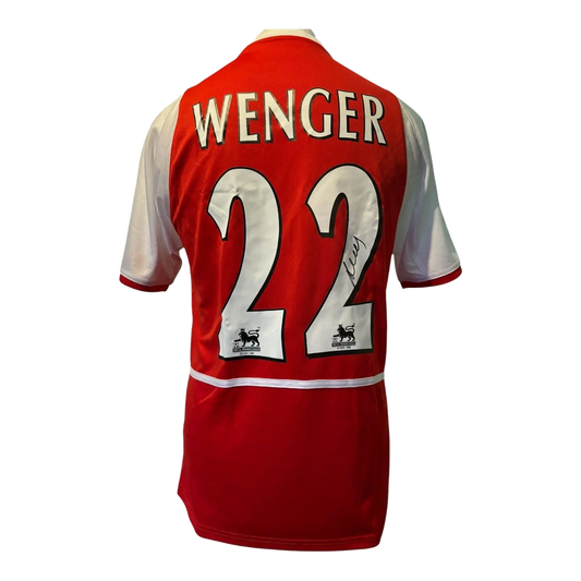 Authentic Arsene Wenger signed Arsenal home shirt, featuring a bold black autograph on the iconic red and white O2 sponsored Invincibles era jersey.