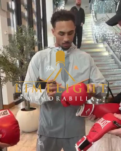 Photographic proof of professional boxer Ben Whittaker signing the boxing glove for authenticity.