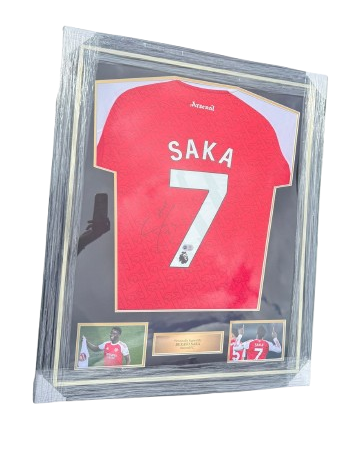 A professionally framed Bukayo Saka hand-signed Arsenal 2025/26 home shirt with custom mounts.