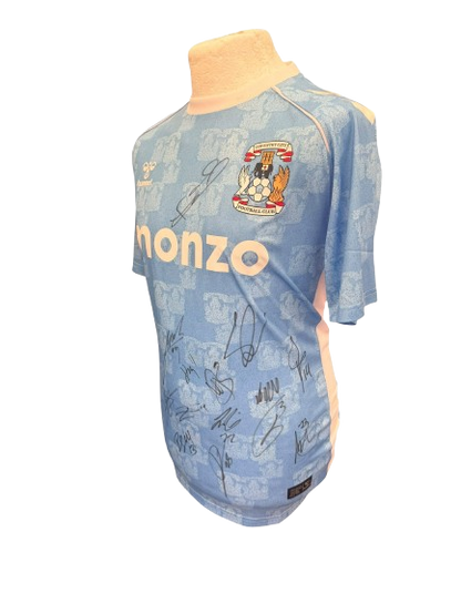 A side profile of the signed Coventry City shirt showcasing the clarity of the player autographs.