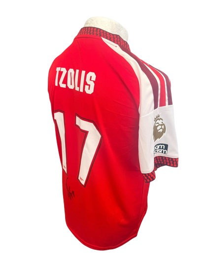 Angled view of the 2026/27 home shirt sleeve showcasing the gold champions badge.