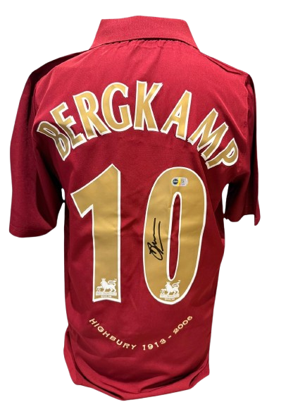 Official 2005/06 Arsenal redcurrant home shirt hand-signed by Dennis Bergkamp in bold permanent ink.