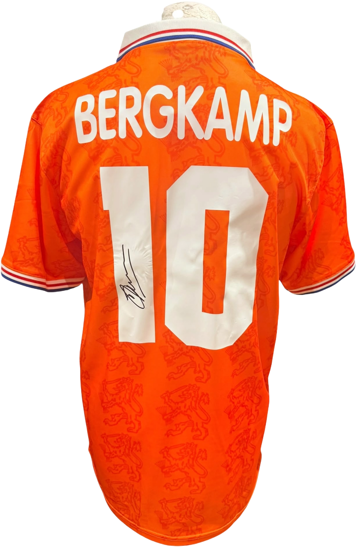 Rear view of a replica retro 1994 Netherlands home shirt hand-signed on the back by forward Dennis Bergkamp, displayed alongside the Certificate of Authenticity.