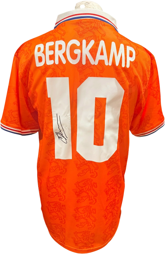 Rear view of a replica retro 1994 Netherlands home shirt hand-signed on the back by forward Dennis Bergkamp, displayed alongside the Certificate of Authenticity.