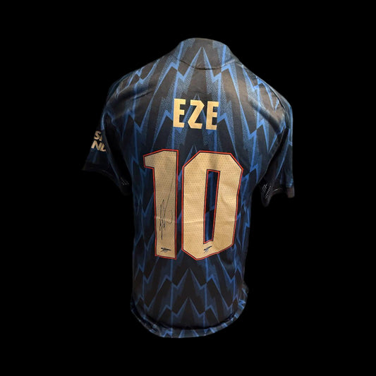 Authentic hand-signed Eberechi Eze Arsenal 25/26 away shirt featuring the iconic lightning bolt design and silver cannon crest.