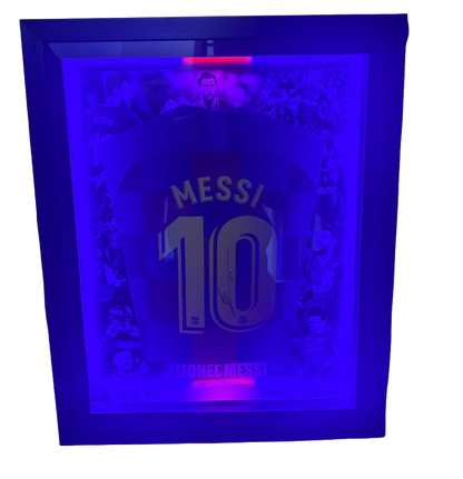 Front view of a framed 2019/20 FC Barcelona home shirt signed by Lionel Messi illuminated with blue and red LED lights.