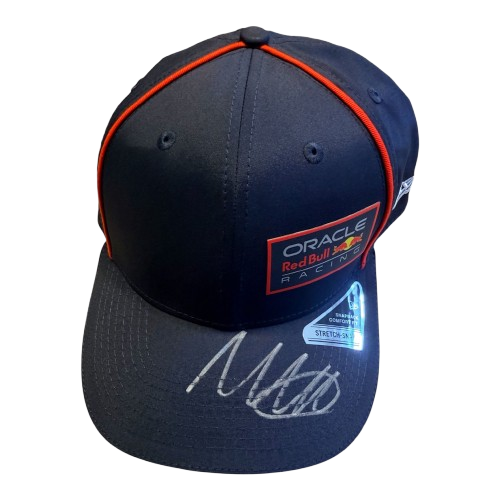 A 45-degree display shot of a Max Verstappen signed Red Bull cap, highlighting the authentic driver branding and unique signature.