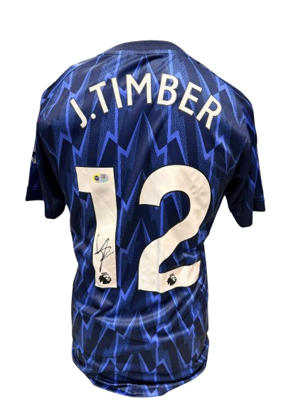 Official 2025/26 Arsenal away shirt hand-signed by Jurrien Timber in bold permanent ink.