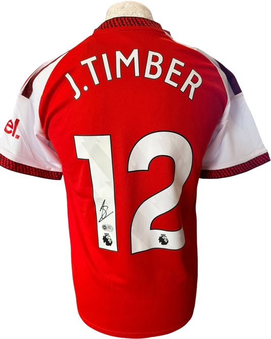 Authentic hand-signed Jurrien Timber Arsenal Home Shirt for the 2026/27 season with a bold signature on the front.