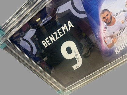 Close-up of Karim Benzema's authentic hand-signed autograph in black marker on a Real Madrid jersey.