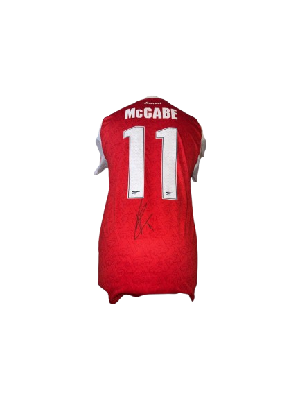 Authentic Katie McCabe signed Arsenal Women home shirt 25/26 featuring a clear black autograph on the classic red and white jersey with tonal Gothic A patterns.