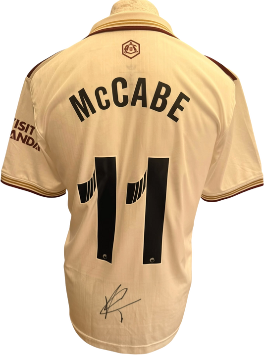 Authentic hand-signed autograph by Katie McCabe across the front of the green and black Arsenal Women 2025/26 third shirt.