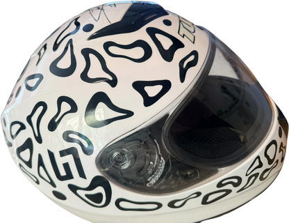 Profile view from the left side of the full-size replica Lando Norris racing helmet, showing intricate sponsor decals and aerodynamic shell design.
