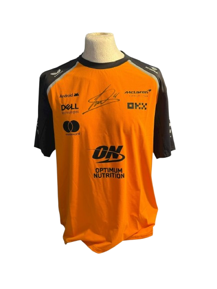 Authentic hand-signed Lando Norris McLaren F1 team shirt with bold autograph.