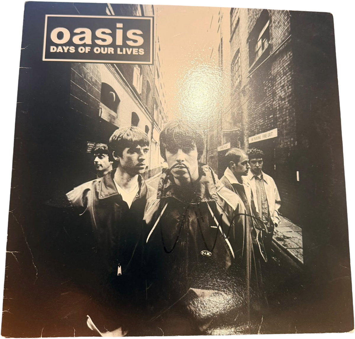 Front view of the Oasis Days of Our Lives live vinyl record sleeve, hand-signed by frontman Liam Gallagher, presented next to its Certificate of Authenticity.