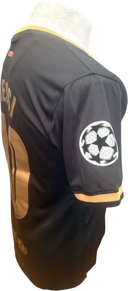 Close-up side view of the Barcelona black away shirt highlighting the Champions League starball sleeve badge detail.