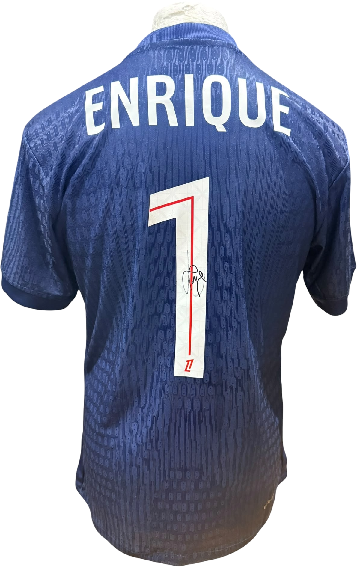 Rear view of a Paris Saint-Germain home shirt hand-signed by manager Luis Enrique, displayed alongside the Certificate of Authenticity.