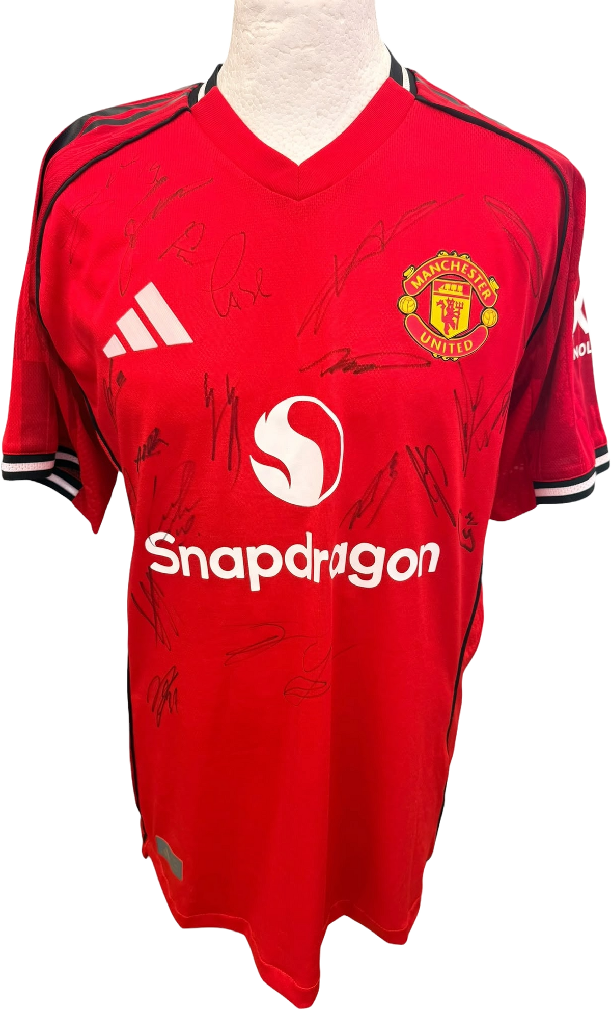 Front view of the authentic player version Manchester United 2025/26 home shirt featuring multiple player signatures in dark ink.