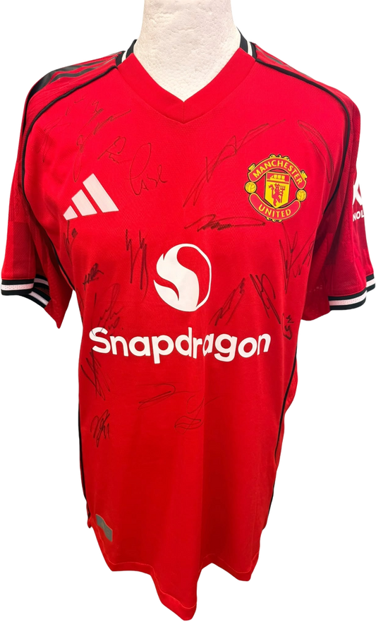 Front view of the authentic player version Manchester United 2025/26 home shirt featuring multiple player signatures in dark ink.