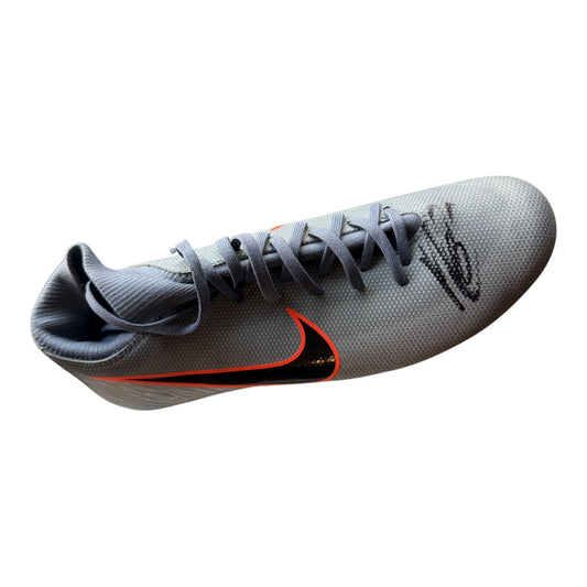 A professional-grade football boot hand-signed by Arsenal captain Martin Odegaard in bold permanent ink on the side, displayed with a Limelight Memorabilia COA.