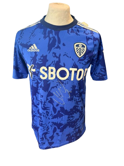 Official Leeds United away shirt hand-signed by midfielder Mateusz Klich in bold permanent ink.