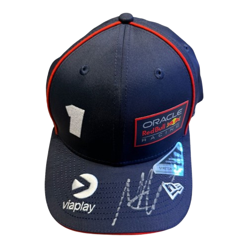 A 45-degree display shot of a Max Verstappen signed Red Bull cap, highlighting the authentic driver branding and unique signature.