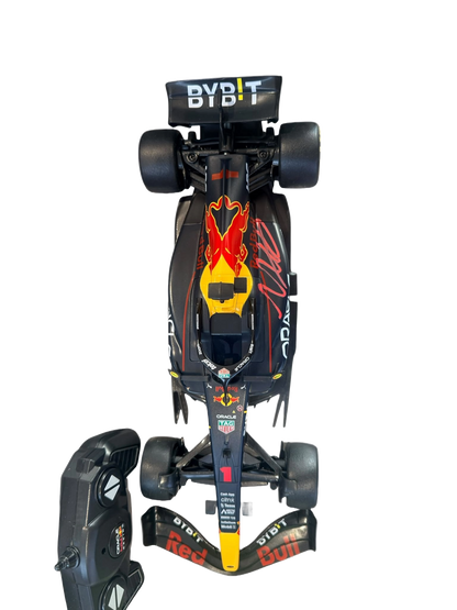 Max Verstappen signed remote control Red Bull F1 car displayed alongside its accompanying handheld remote control unit.