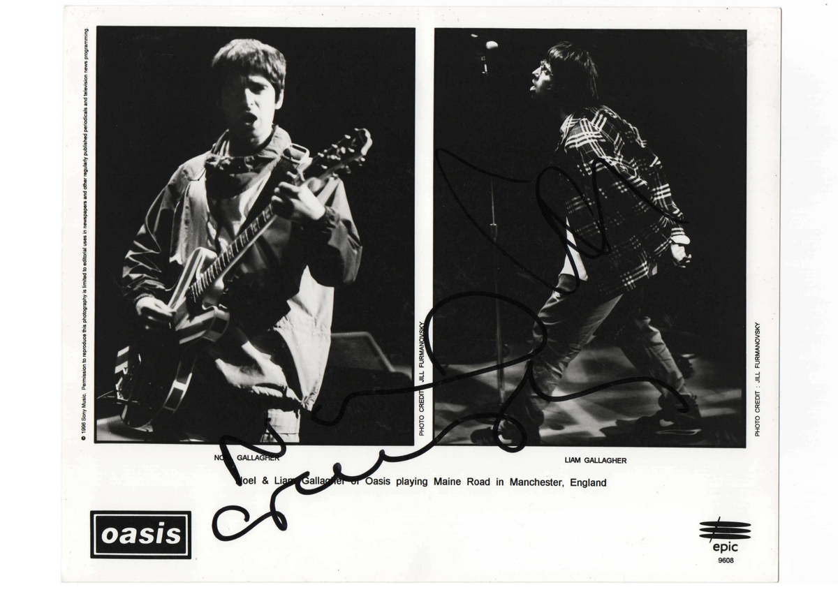 Authentic promotional poster card hand-signed by Noel and Liam Gallagher of Oasis.