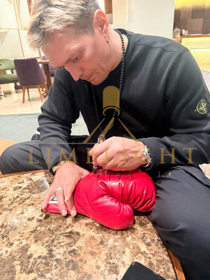 Photo evidence of Oleksandr Usyk hand-signing boxing gloves and adding cat drawings during an exclusive private signing session