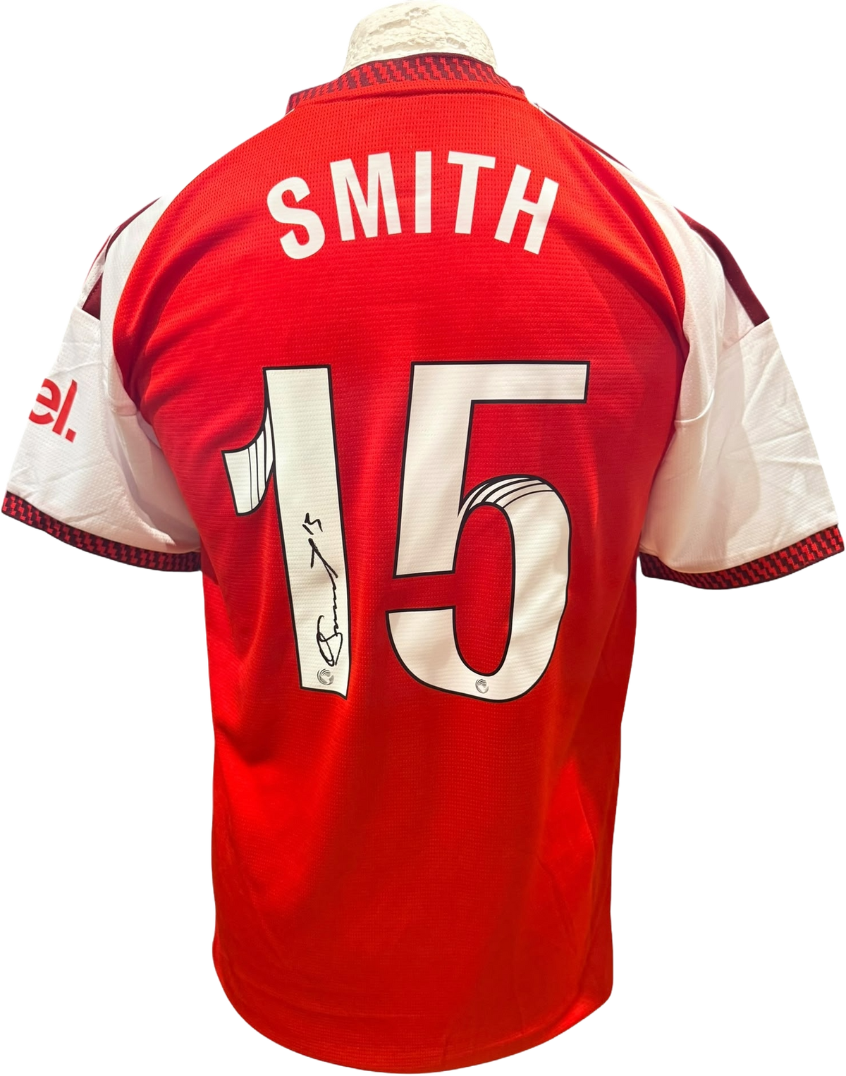 Rear view of a replica Arsenal Women 2026/2027 home shirt hand-signed by forward Olivia Smith, displayed alongside the Certificate of Authenticity.