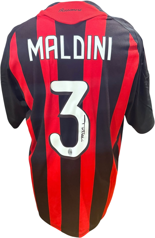 Rear view of a replica retro AC Milan home shirt hand-signed on the back by defender Paolo Maldini, displayed alongside the Certificate of Authenticity.