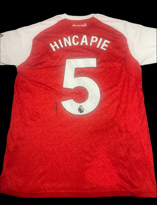 Authentic hand-signed Piero Hincapié Arsenal 25/26 home shirt featuring the classic red and white design and cannon crest.
