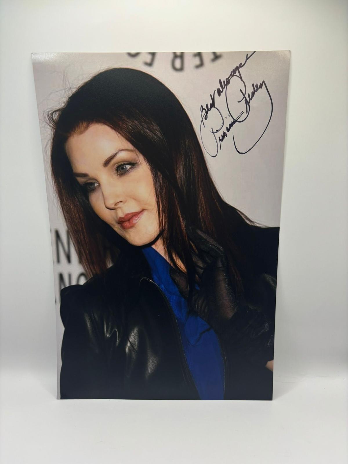 A timeless black and white headshot of Priscilla Presley, hand-signed in the corner with a bold, clear autograph and accompanied by a Limelight Memorabilia COA.