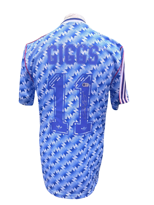 Back view of a blue and white snowflake 1990/91 Manchester United away shirt hand-signed directly on the squad number by Ryan Giggs.
