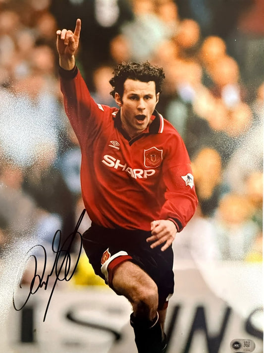 Ryan Giggs celebrating his winning goal in the 1996 Manchester derby against Manchester City, hand-signed in permanent marker.