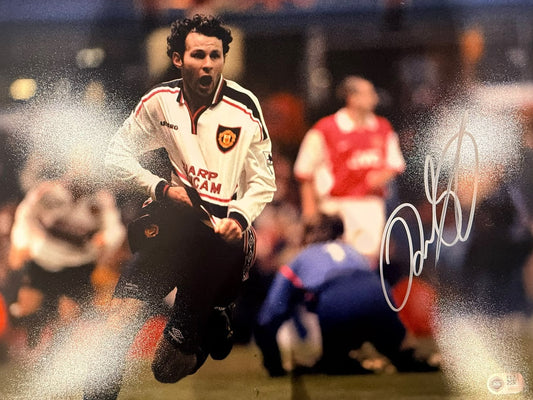 Ryan Giggs celebrating his legendary solo goal against Arsenal in the 1999 FA Cup semi-final replay at Villa Park, hand-signed in permanent marker.