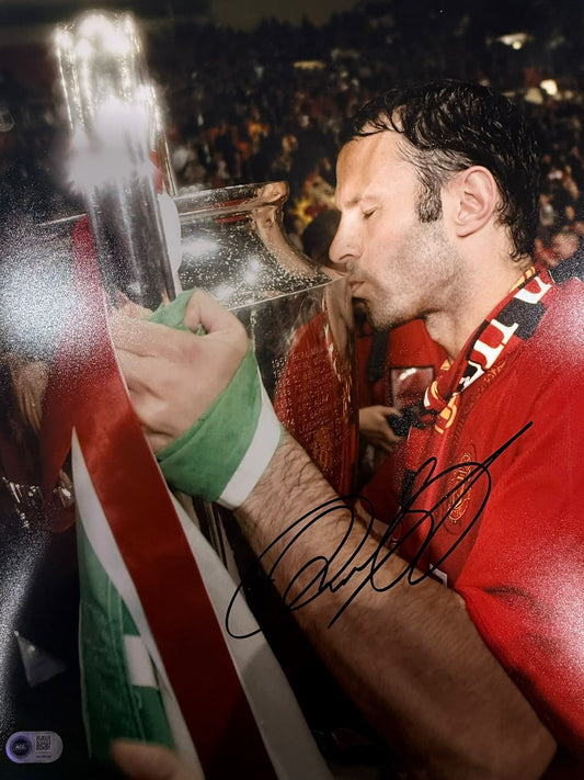 Ryan Giggs kissing the Champions League trophy during the 2008 Moscow celebrations, hand-signed in permanent marker.