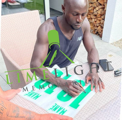 Signed photo proof of Sadio Mane hand-signing the Senegal AFCON winners shirt for Limelight Memorabilia.